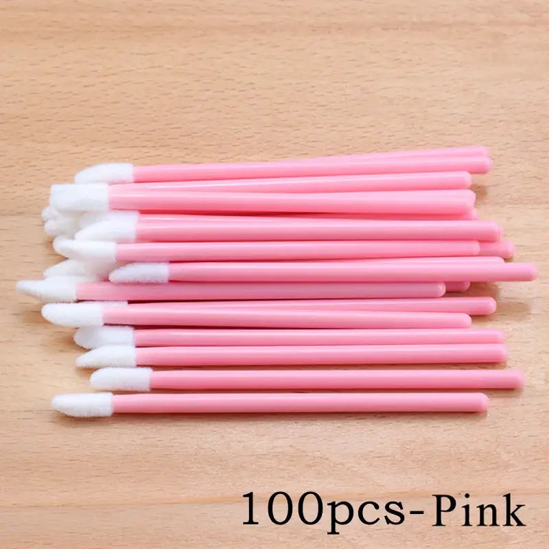 Pink disposable lip brushes.