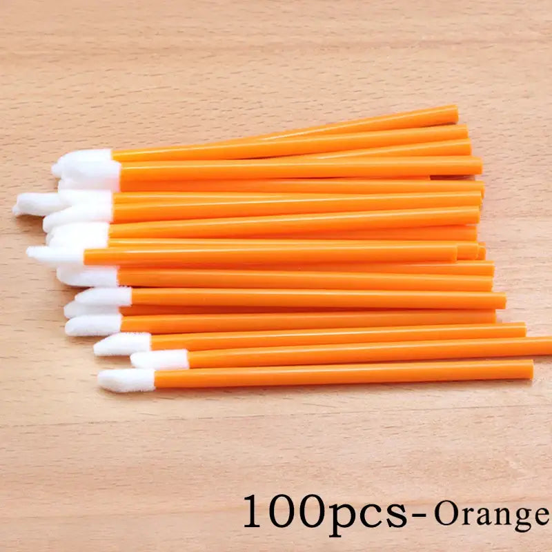 Orange disposable applicators with white tips.