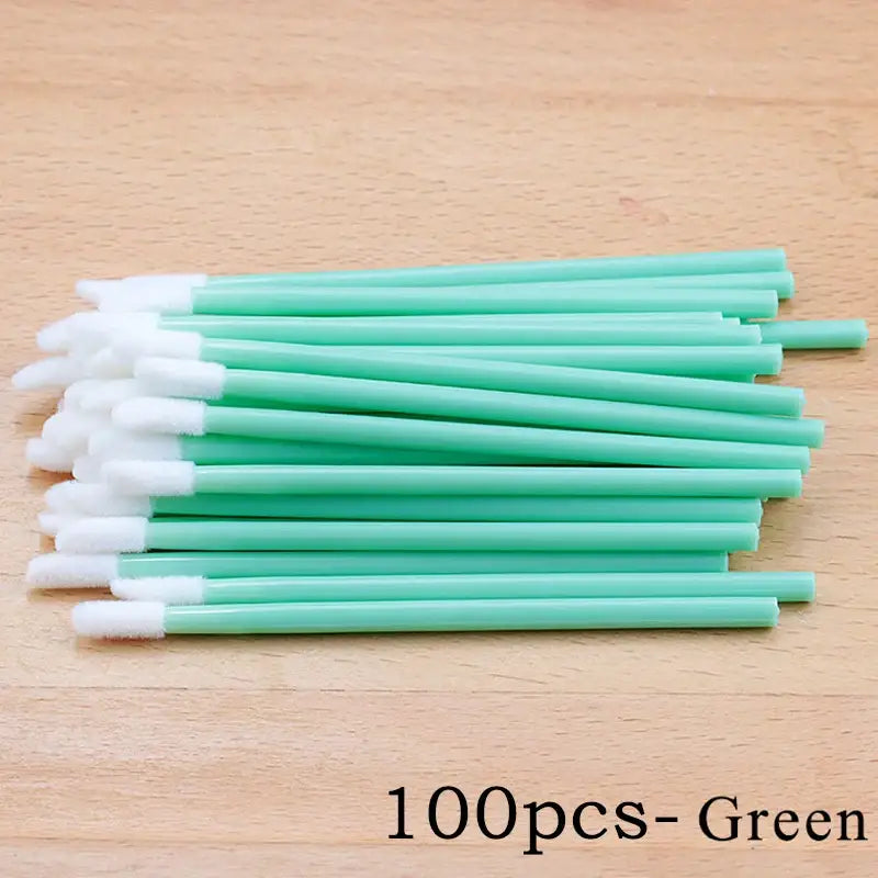 Green disposable lip brushes.