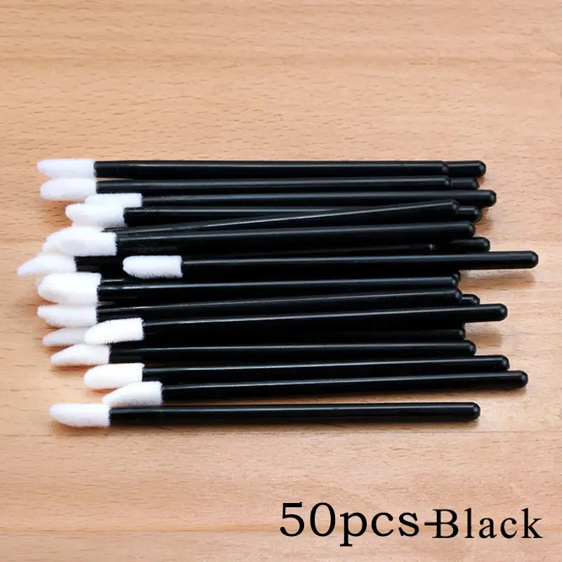 Black disposable lip brushes.