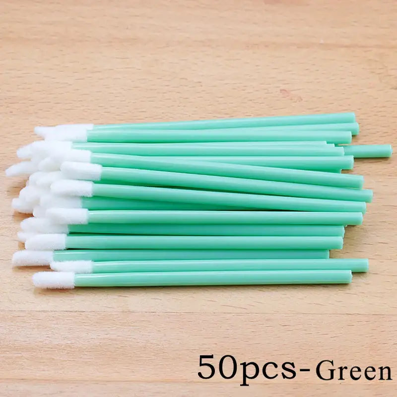 Green disposable lip brushes.
