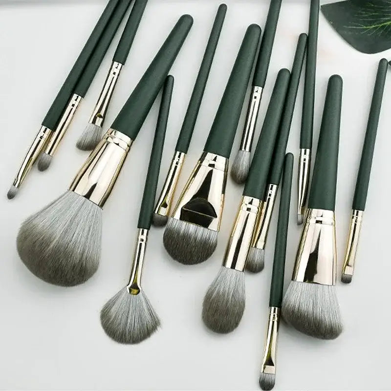 Makeup brush set with green handles.