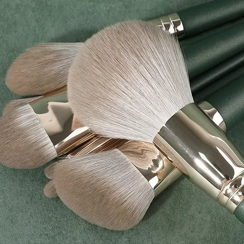 Makeup brushes with green handles.
