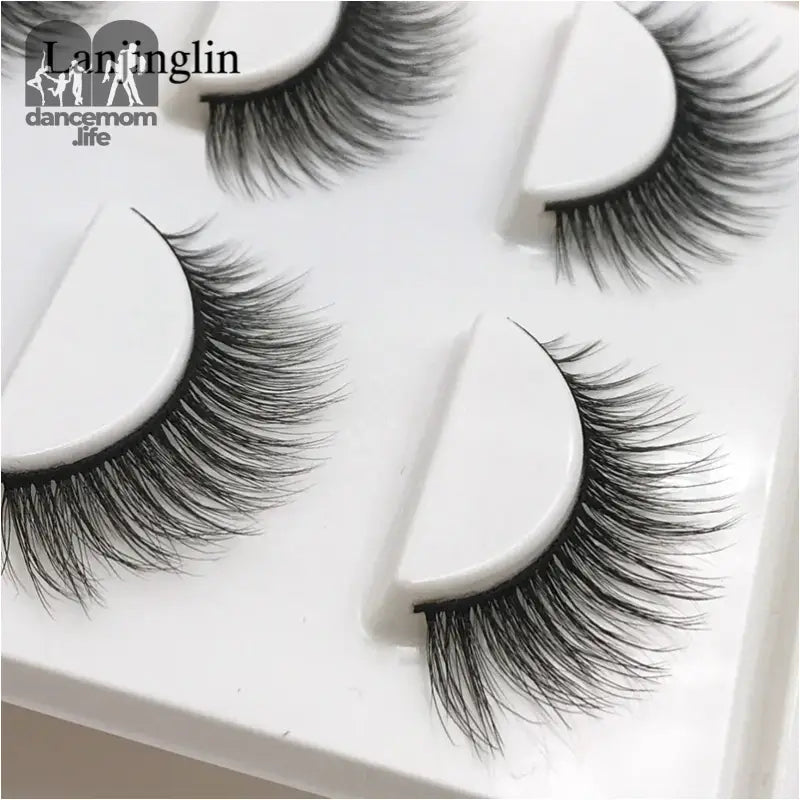 False eyelashes on white plastic trays.