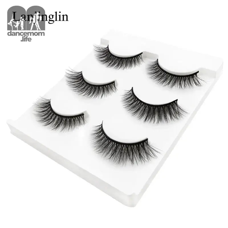 False eyelashes on a white tray.