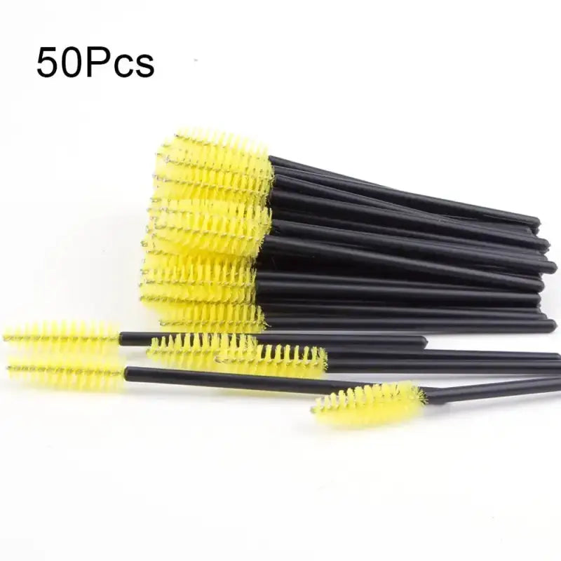 Yellow-bristled mascara wands with black handles.