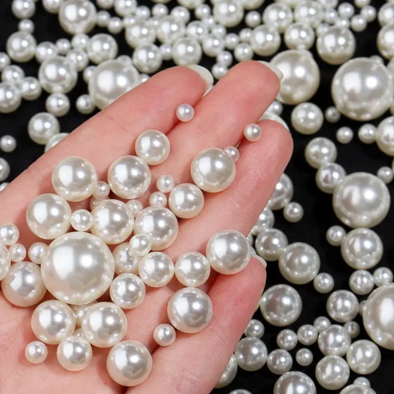 Lustrous white pearls resting on a palm.