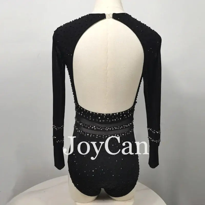 Black backless leotard with long sleeves and crystal embellishments.