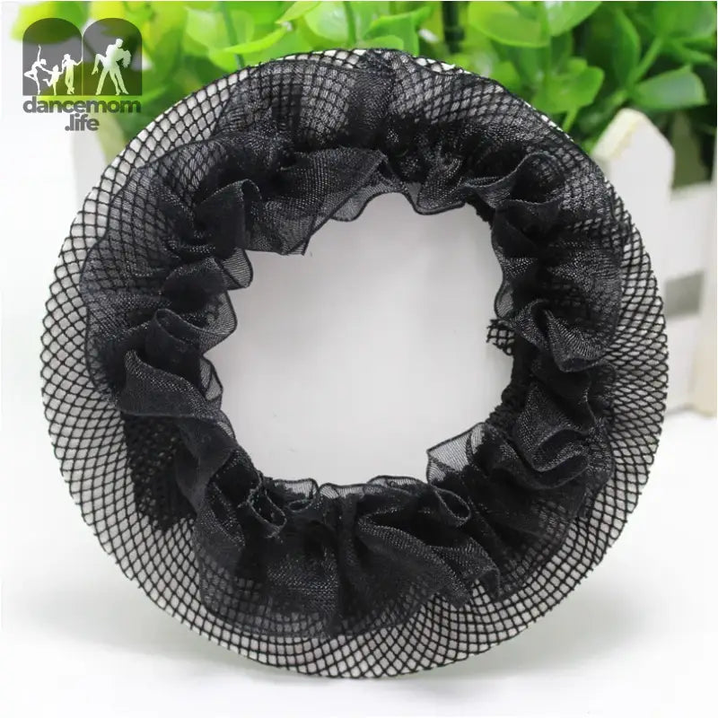 Black mesh scrunchie with ruffled edges arranged in a circular shape.