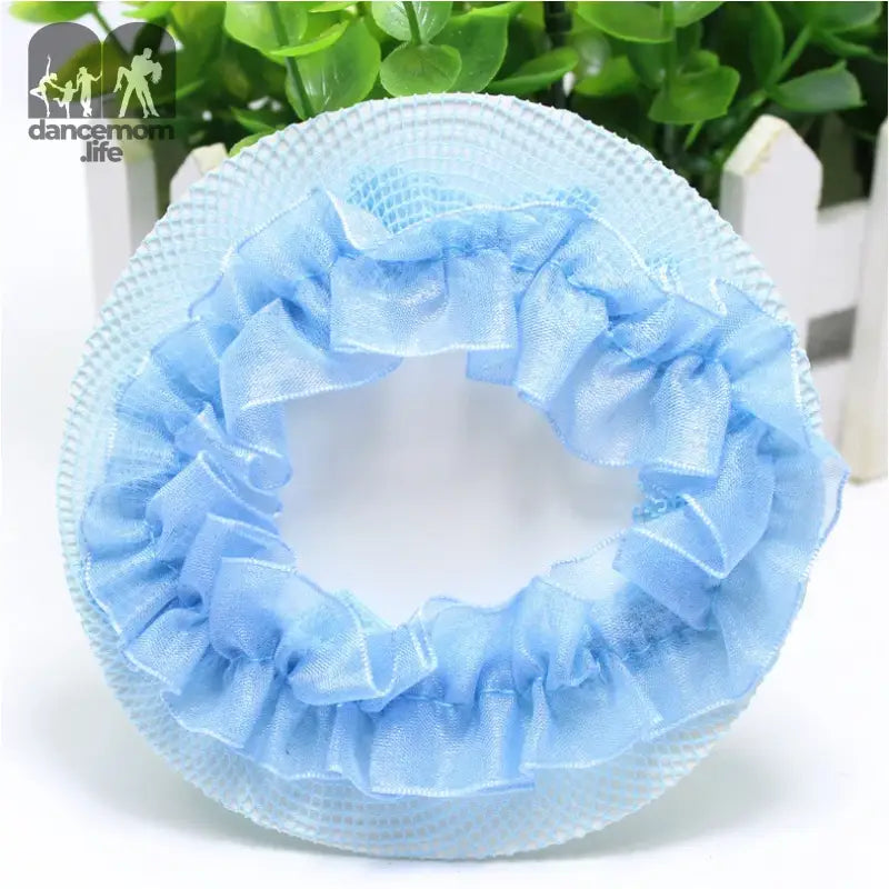 Light blue ruffled shower cap with elastic edges.