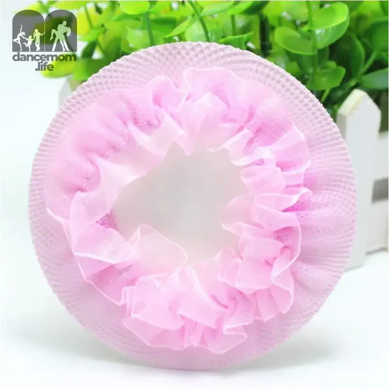 Pink ruffled shower cap with a circular shape.