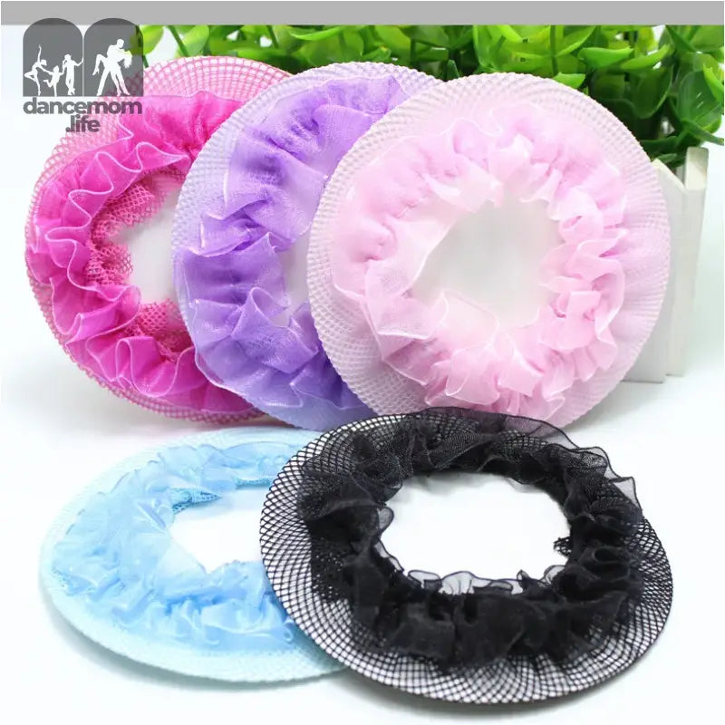 Colorful mesh shower caps in pink, purple, light pink, blue and black with ruffled edges.
