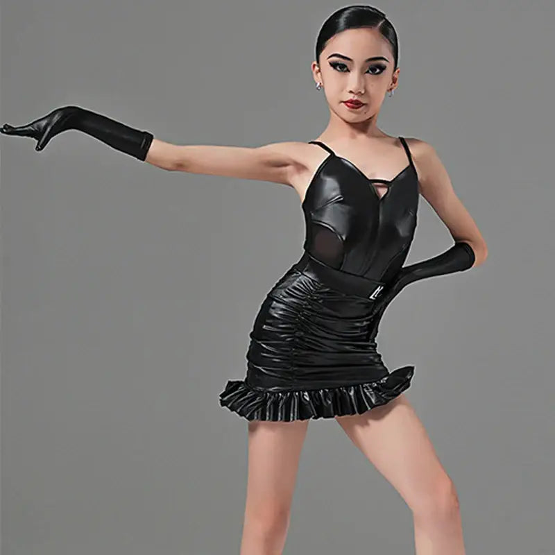Black leather dance costume with a ruffled mini skirt and long gloves.