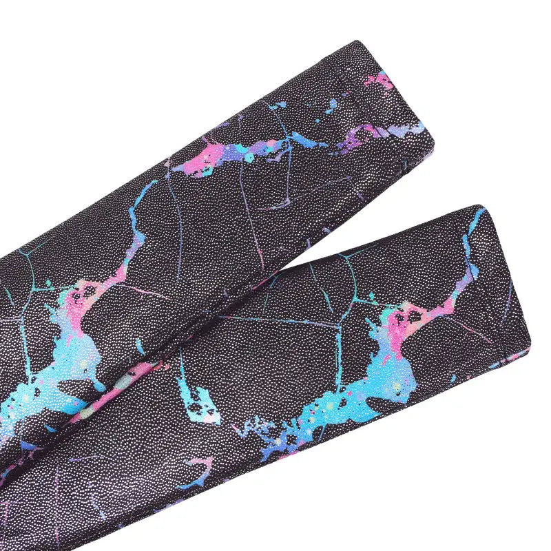 Black cricket bat grip with blue and pink marble-like pattern.