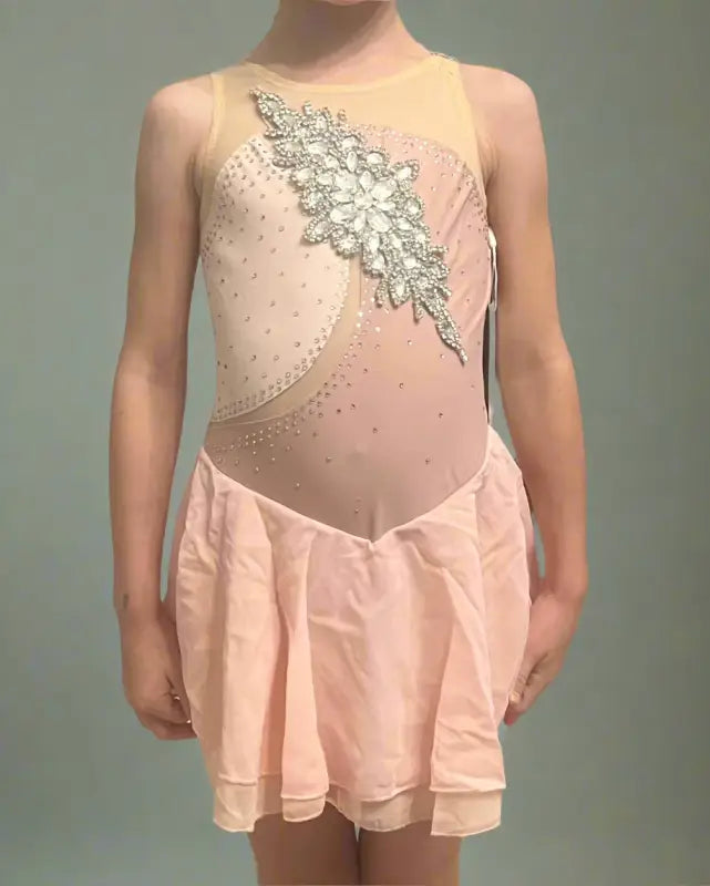 Pink figure skating dress with a sparkly floral design on the bodice.