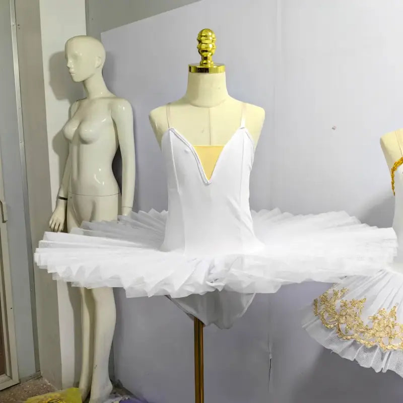 White classical ballet tutu with spaghetti straps and platter-style skirt.
