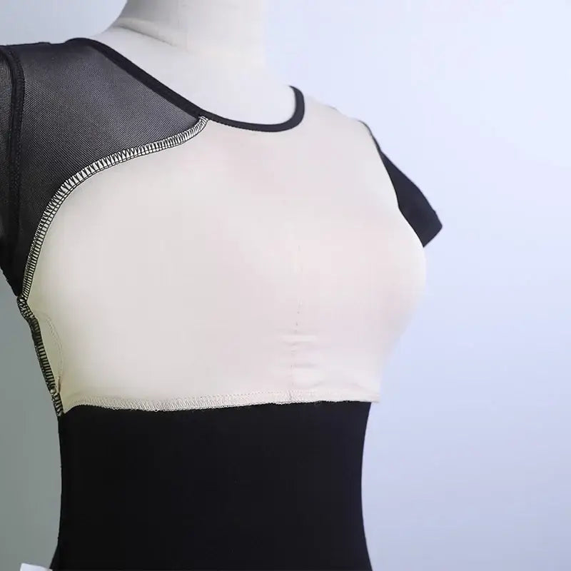 Black and white dance leotard with contrast stitching detail.