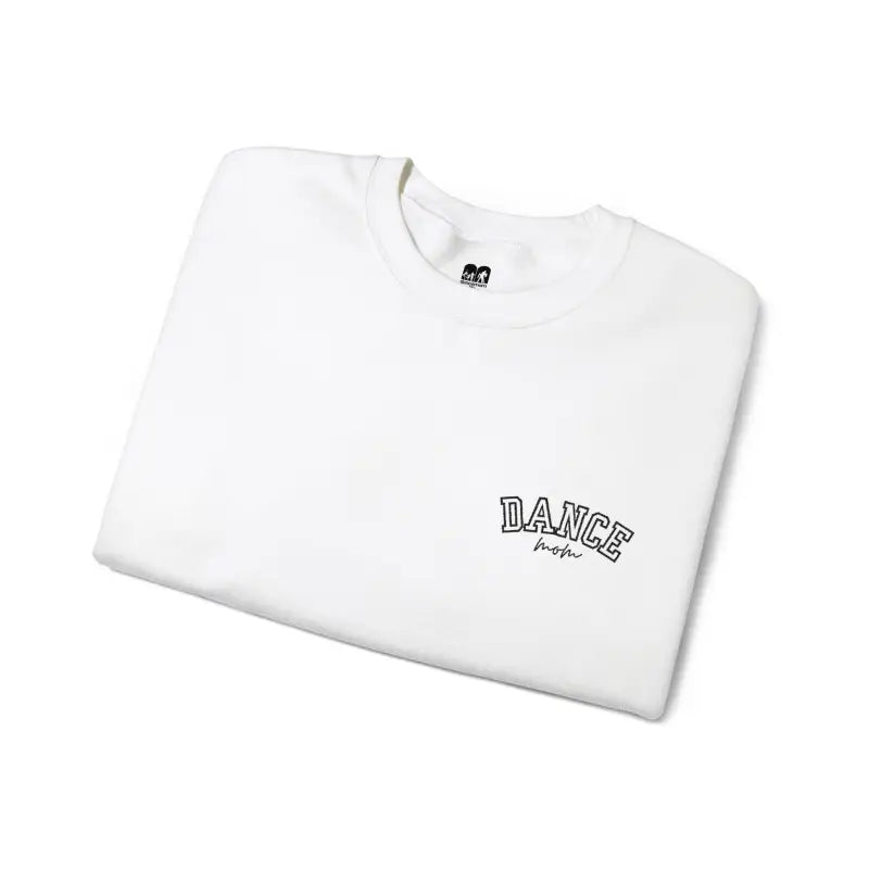 White t-shirt with ’DANCE’ text embroidered on it.
