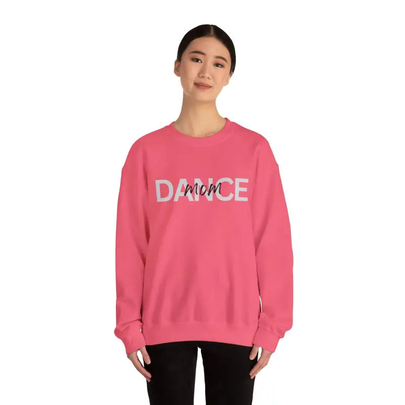 Pink crewneck sweatshirt with ’DANCE’ text printed on the front.