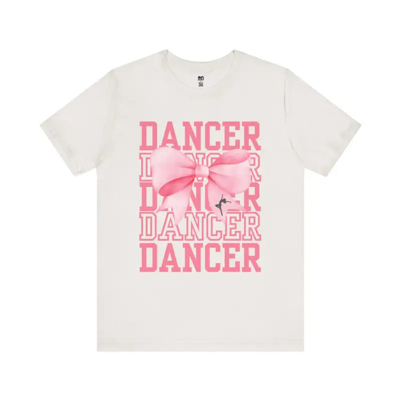 White t-shirt with pink ’DANCER’ text and bow design printed on the front.