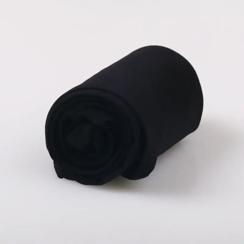 Black rolled-up fleece blanket.