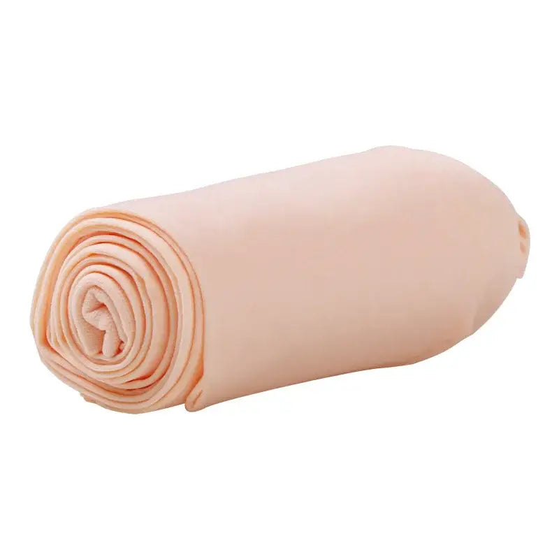 Rolled-up peach-colored fabric or textile material.