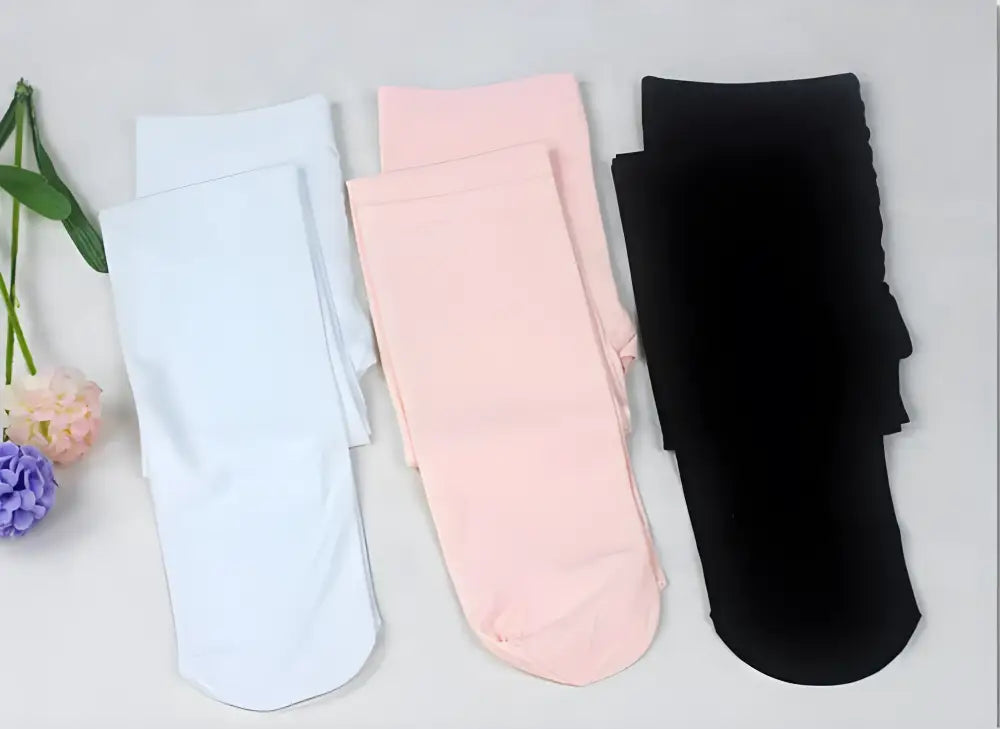 Three pairs of socks in white, pink, and black colors.