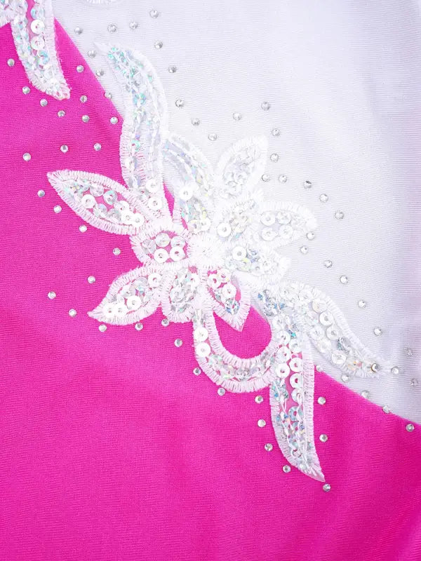 White lace and sequin floral appliqué on pink fabric.