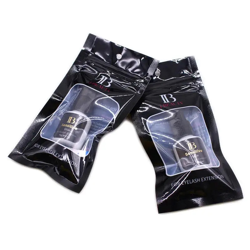 Two black pouches of eyelash extension glue.
