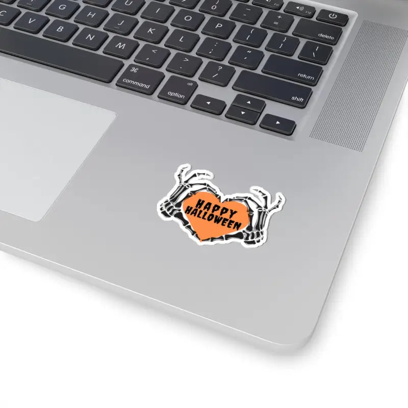 Halloween-themed sticker featuring skeleton hands holding an orange speech bubble with ’Happy Halloween’ text.