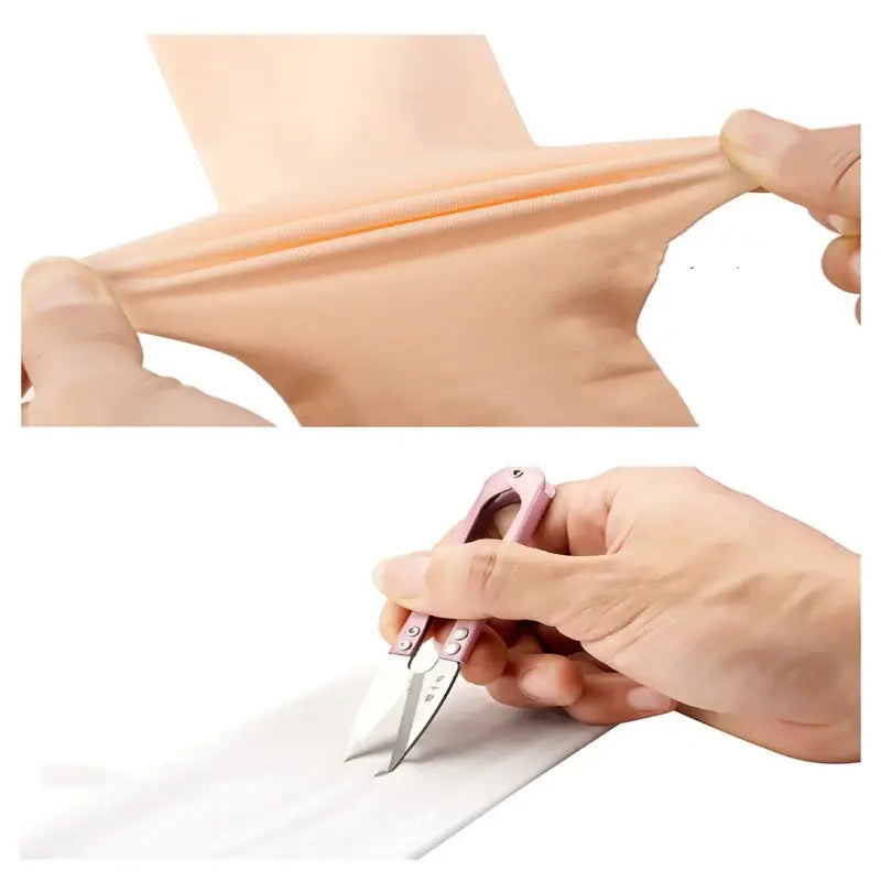 Hands stretching and cutting a piece of elastic or rubber material.