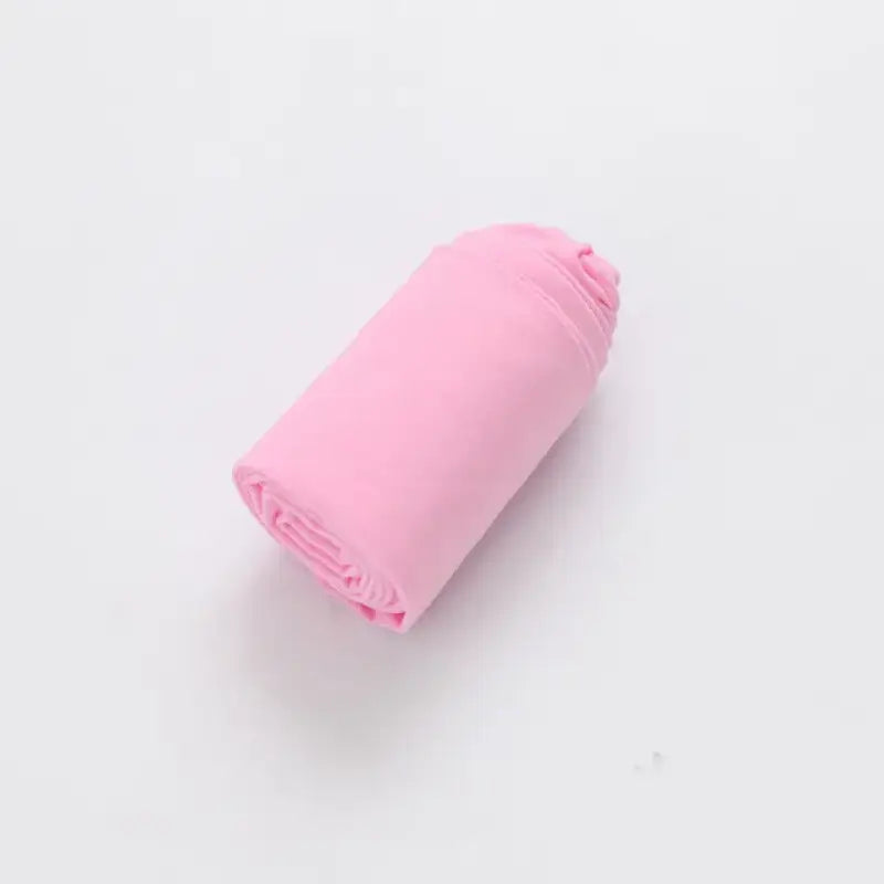 Pink rolled-up fabric or textile material.