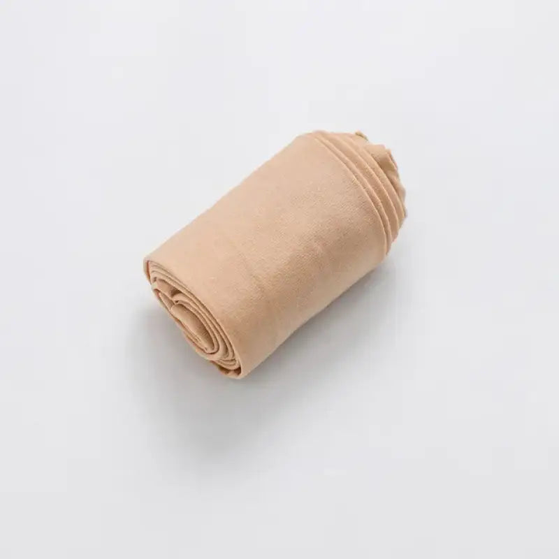 Rolled up beige fabric or cloth.
