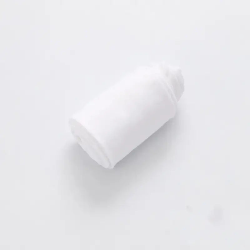 White plastic bottle cap lying on its side.