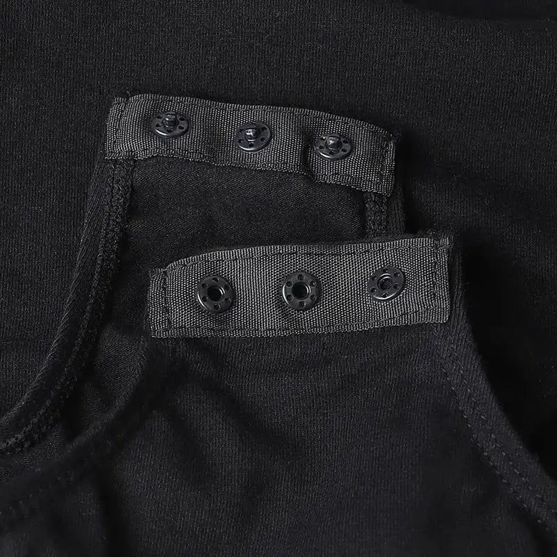 Black fabric garment with snap button closures.