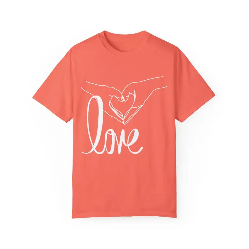 Coral-colored t-shirt with white hands forming a heart shape and ’love’ text design.