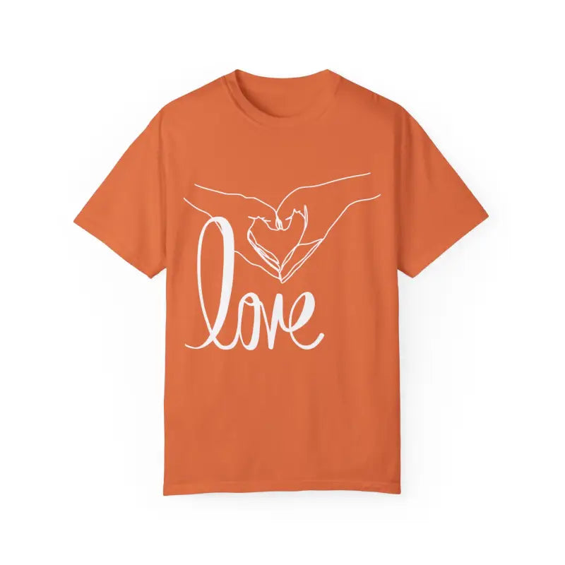 Orange t-shirt with white hands forming a heart shape and the word ’love’ printed on it.