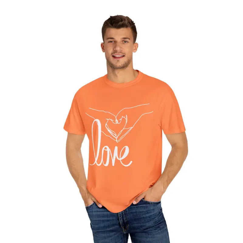 Orange t-shirt with a white ’love’ design featuring hands forming a heart shape.