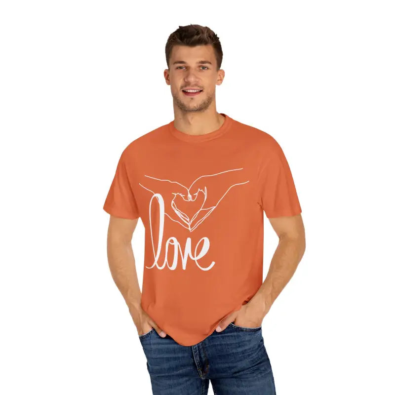 Orange t-shirt with white ’love’ text and hand design on the front.