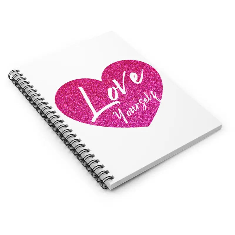 Spiral-bound notebook with a pink glittery heart and ’Love yourself’ text on the cover.