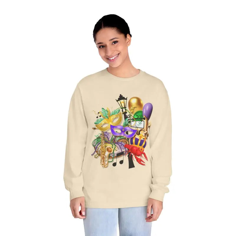 Beige sweatshirt featuring colorful Mardi Gras themed artwork with masks, musical notes, and festive decorations.