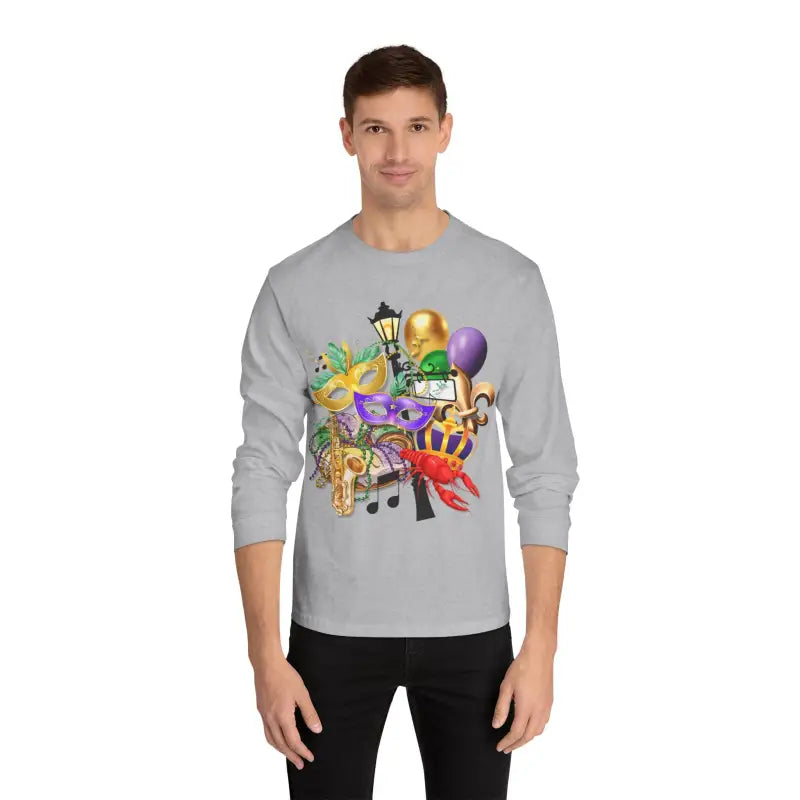 Light gray long-sleeve t-shirt with colorful Mardi Gras themed artwork featuring masks, balloons, and musical notes.