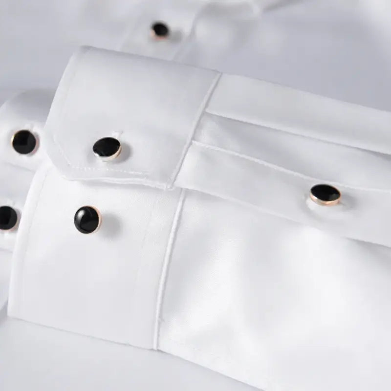 White dress shirt cuffs with black buttons.
