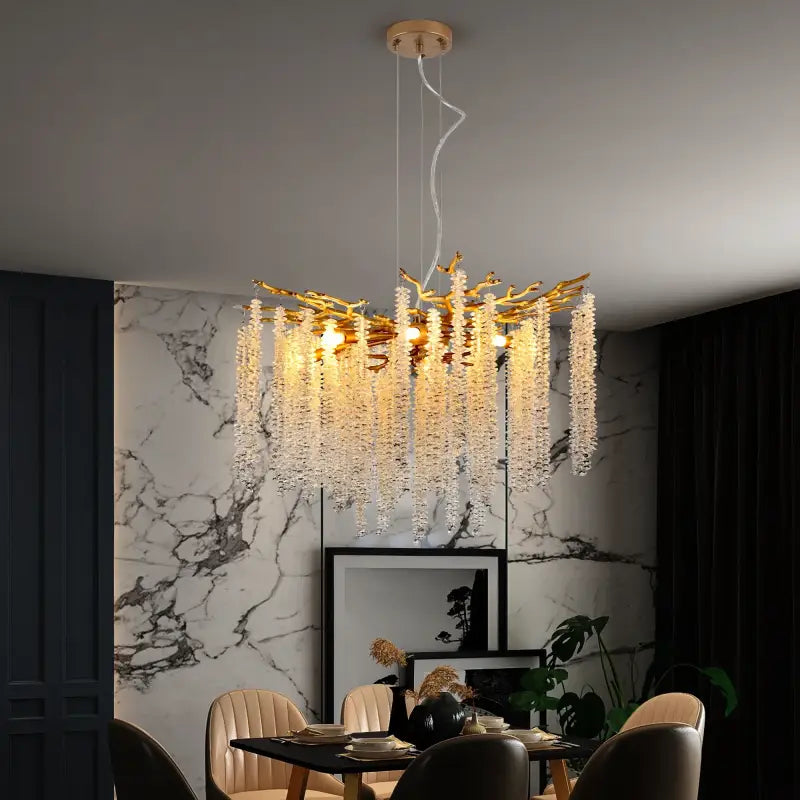 Gold branch chandelier with crystal strands.