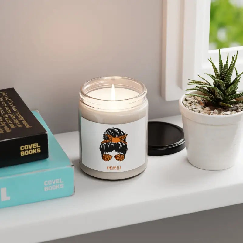 Glass jar candle with a cartoon messy bun and sunglasses design on its label.