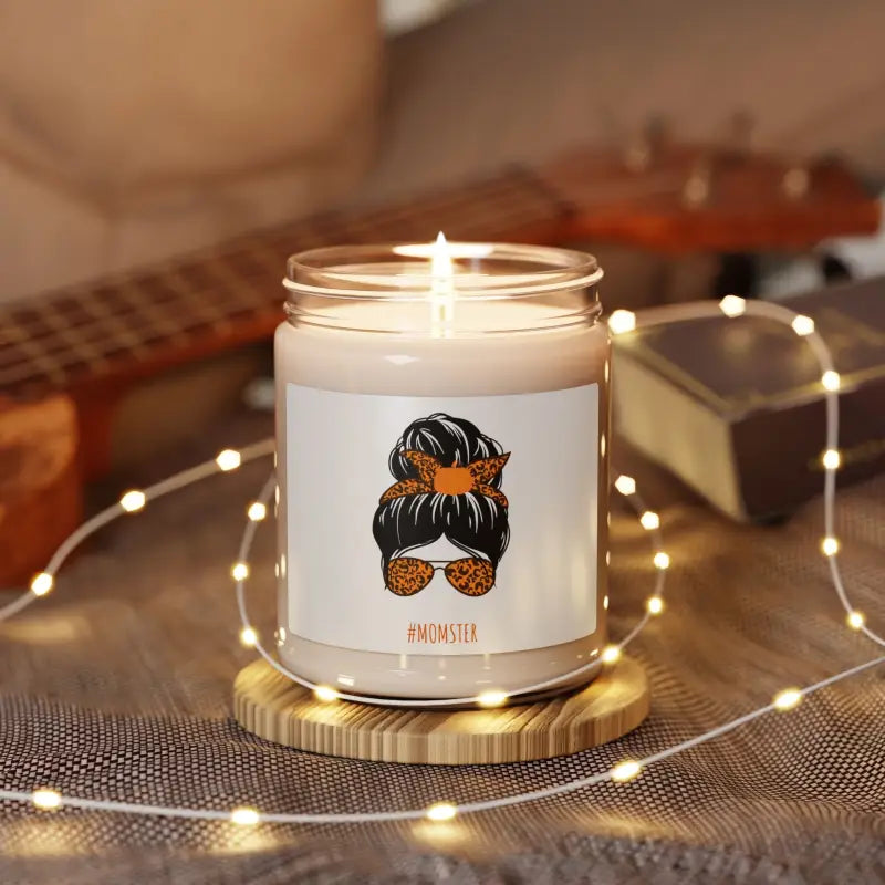 White jar candle with an illustration of a messy bun hairstyle and sunglasses on the front.