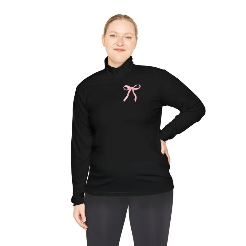 Black turtleneck sweater with a pink bow embellishment on the chest.