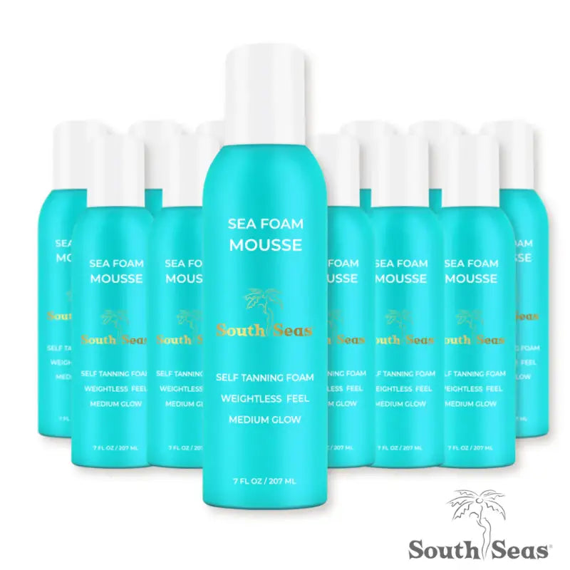 Multiple bottles of turquoise self-tanning mousse.