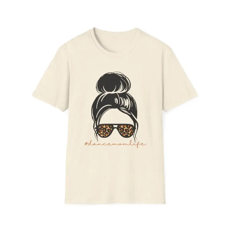 Cream-colored t-shirt featuring a messy bun hairstyle illustration with leopard print sunglasses.
