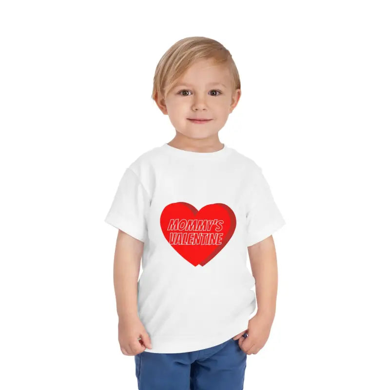 White t-shirt with a red heart design containing text.